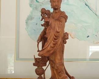 Chinese boxwood carving of the goddess Guan Yin holding flowers