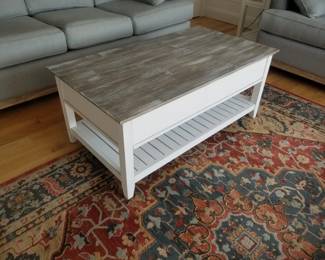 Coffee table with drawers; area rug