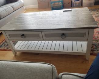 Coffee table with drawers; area rug