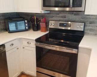 Duplex - two identical kitchens! GE electric range; GE microwave oven mfg. 9/2020