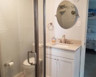 Vanity lights; mirror; bath vanity; toilet