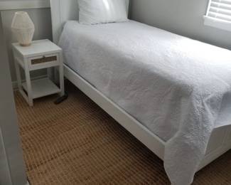 Twin bed; nightstand; rug