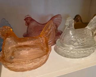 Many hens on nest, including Indiana Glass, milk glass, Longaberger and a unique design with a chick under hen