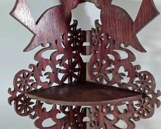 Victorian-style mahogany fretwork corner shelf with bird and floral carvings