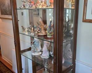 Large full length ornate frame curio cabinet with glass shelving and lights. Figurines and decor on shelves offered separately, several different makers