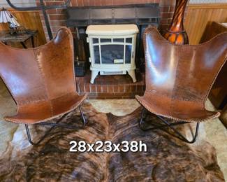 Pair of leather butterfly chairs with iron frames. Genuine cowhide rug