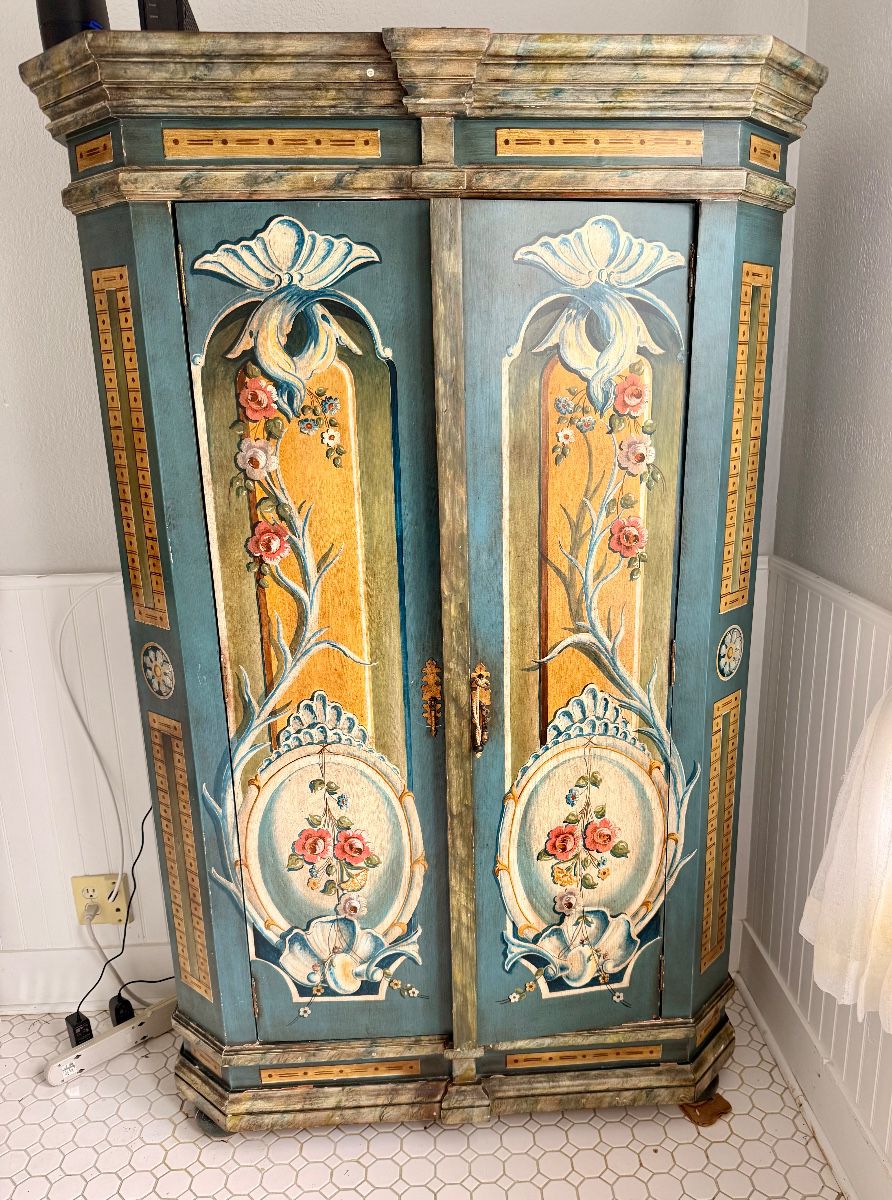 Striking Vergara-Art hand-painted armoire with elaborate polychrome floral decoration, original hardware, and vivid red-orange interior storage; handmade in Spain.