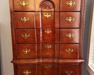 Beautiful Queen Anne-style highboy with carved detailing, cabriole legs, and multiple drawers for stylish bedroom storage.