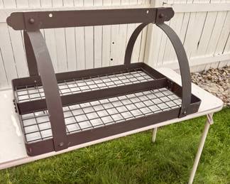 Heavy-duty decorative wrought iron ceiling-mounted pot rack with hanging bar and wire shelf, perfect for storing and displaying cookware, utensils, or kitchen décor.