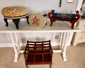 Collection of vintage footstools, needlepoint accents, and a wooden magazine rack that bring classic charm to any home.