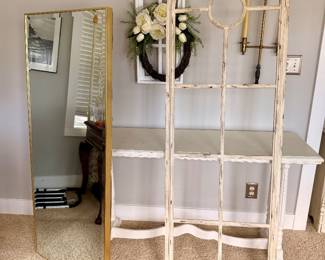 Decorative arched metal window frame with distressed white finish, perfect for farmhouse or cottage décor. Modern full-length floor mirror with slim gold metal frame.