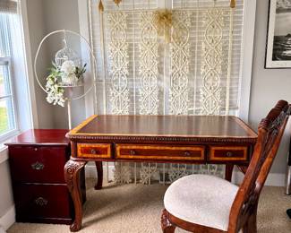 Beautiful executive writing desk with leather-look top, carved details, matching upholstered chair, and coordinating file cabinet available.