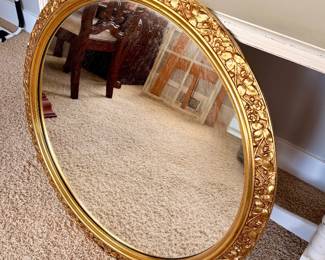 Ornate oval gold-framed mirror with a classic floral design—perfect as an entryway, bedroom, or vanity accent.
