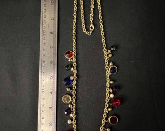 Lot 117: Gold-tone beaded necklace with multicolored charms and red enamel crescent earrings
