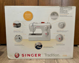 Lot 180: Vintage Singer Tradition 2250 sewing machine box with quilting binding and bias tape packs