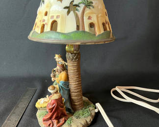 Lot 102: Decorative palm-tree lamp with nativity scene shade and Lenox dolphin figurine