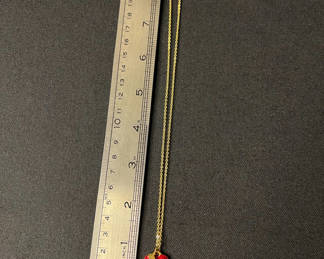 Lot 106: Gold-tone jewelry collection with heart pendant, charm bracelet, and drop earrings