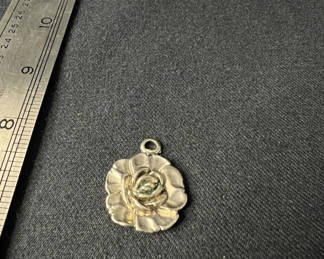 Lot 125: Assorted pendants: flower, shell, and cabochon disk