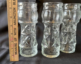 Lot 20: Three tall ribbed glass tiki glasses, round candle holder, and two star-shaped glass candle holders