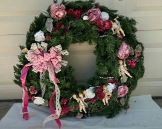 Lot 69: Vintage Evergreen Christmas cherub wreath and decorative greens with candle and vases