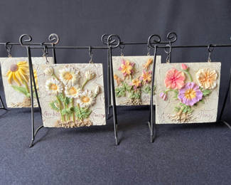 Lot 35: Floral embossed ceramic tiles on metal display stands, sculpted ceramic yellow rose