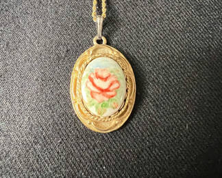 Lot 115: Gold-tone cameo pendant necklace with floral center, purple chip earrings, and two-tone circular earrings