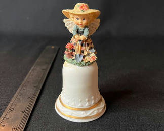 Lot 104: Ceramic bell with angel girl figurine on top