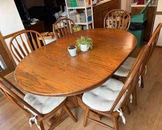 oak dining table and eight Windsor chairs; 48"x 68" as shown. plus two 12" leaves and two more chairs