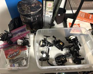 Variety of fishing reels, lures, hiking sticks.