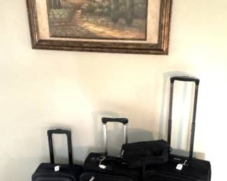 Luggage and framed wall art.