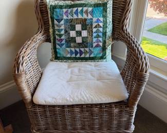 Ikea wicker chair with white seat pad. 1 of 2. Set is $50. Blue quilted pillows not included.