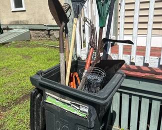 348 assortedlawntoolsintrashbin