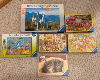 A sampling of the large selection of puzzles, including 3D puzzles and sets by Ravensburger and Springbok