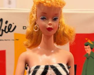 Ca. 1961 Barbie with original black & white swim suit, black heels, high pony tail and white w/ blue lense cat eye sunglasses.  She will be sold separately from the Barbie case and other accessories