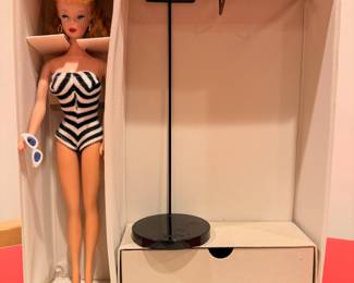 Ca. 1961 Barbie with original black & white swim suit, black heels, high pony tail and white w/ blue lense cat eye sunglasses.  She will be sold separately from the Barbie case and other accessories