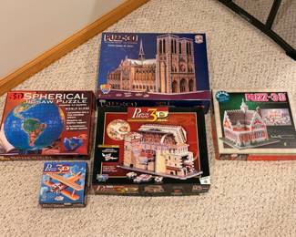 A sampling of the large selection of puzzles, including 3D puzzles and sets by Ravensburger and Springbok