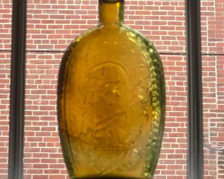 Amber bottle flask featuring George Washington and an Eagle. A Bicentennial replica.
