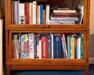 This is an antique two-stack oak barrister bookcase that features classic glass lift-up doors and a warm medium wood finish.