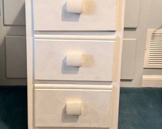 This is a vintage small white wooden bedside nightstand featuring three drawers with matching square block knobs.