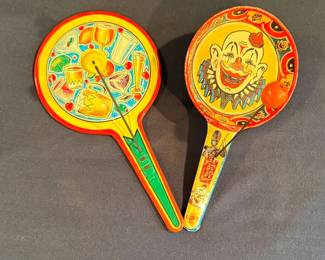 These vintage tin litho paddle party noisemakers feature colorful cocktail and beverage graphics, produced by mid-20th-century maker U.S. Metal Toy Mfg. Co.