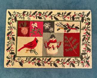 This holiday accent rug is the Nourison Essential Elements Snowman and Cardinal Multicolor Rug, featuring a hand-hooked multi-panel winter theme with a cardinal and snowman