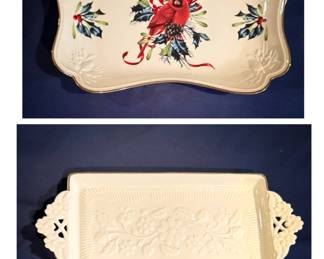 On the top we have a Lenox Winter Greetings Canapé Tray, featuring a festive red cardinal, holly accents, and gold trim. Underneath is a Lenox classic ivory ceramic vanity and serving tray featuring delicate embossed floral and leaf details with a charming pierced side handles and gold trim.