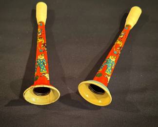 These are vintage lithographed tin clown and circus motif party horn noisemakers made by the U.S. Metal Toy Manufacturing Company during the 1950s or 1960s.
