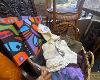 Linens, oil abstract art, chairs hanging from the rafters, chairs stacked on top of each other
