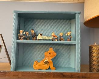 Vintage Pig Figurine Set with Wooden Bear Clock on Blue Wicker Shelf