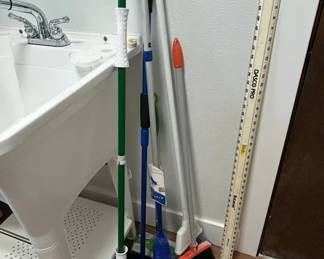 Assorted Household Cleaning Tools and Dasco Pro Level