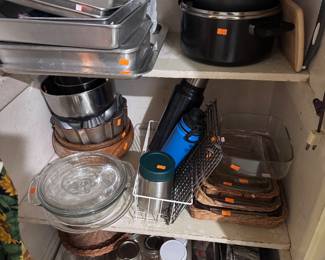 glass casseroles withe wicker holders, pans and cookware