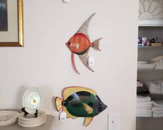 Painted metal fish plaques.