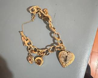 Vintage Gold Tone Charm Bracelet with Heart Locket, Moon, and Red Gemstone Charm