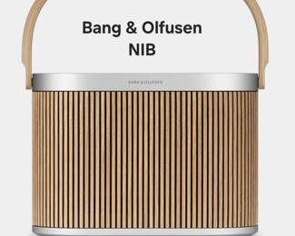 Bang & Olufsen Beosound A5 in Oak features a natural wood handle and a slatted wood front grill design. New in box